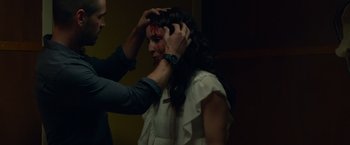 Movie still from “Dead Man Down” (2013), directed by Niels Arden Oplev – A man is putting makeup on a woman's face; Close Up shot, Over the shoulder angle