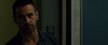 Movie still from “Dead Man Down” (2013), directed by Niels Arden Oplev – A person wearing a black shirt; Close Up shot, Over the shoulder angle