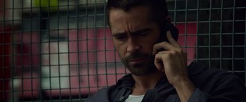 Movie still from “Dead Man Down” (2013), directed by Niels Arden Oplev – A person talking on a cell phone; Close Up shot, Over the shoulder angle