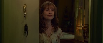 Movie still from “Dead Man Down” (2013), directed by Niels Arden Oplev – A woman standing in front of a wall with her eyes closed; Close Up shot, Over the shoulder angle