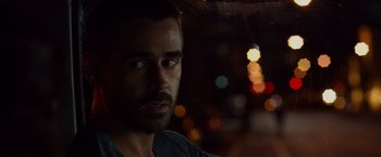 Movie still from “Dead Man Down” (2013), directed by Niels Arden Oplev – A person looking at the camera; Close Up shot, Over the shoulder angle