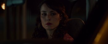 Movie still from “Dead Man Down” (2013), directed by Niels Arden Oplev – A person sitting in a car; Close Up shot, Over the shoulder angle