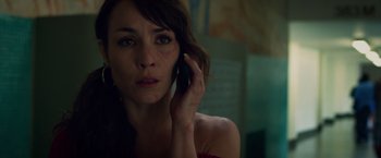 Movie still from “Dead Man Down” (2013), directed by Niels Arden Oplev – A woman holding a cell phone up to her ear; Close Up shot, Low angle