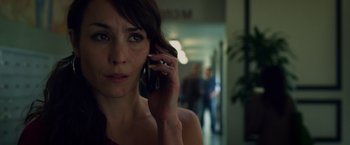 Movie still from “Dead Man Down” (2013), directed by Niels Arden Oplev – A person talking on a cell phone; Close Up shot, Low angle