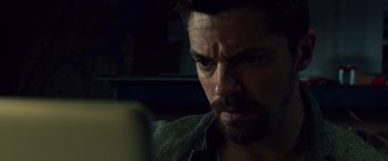 Movie still from “Dead Man Down” (2013), directed by Niels Arden Oplev – A person looking at a computer screen; Close Up shot, Low angle