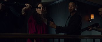 Movie still from “Dead Man Down” (2013), directed by Niels Arden Oplev – A man holding a gun next to a woman in front of a railing; Medium shot, Over the shoulder angle