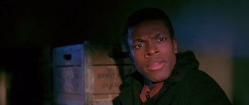 Movie still from “Dead Presidents” (1995), directed by Albert Hughes – A person wearing a green jacket; Close Up shot, Low angle