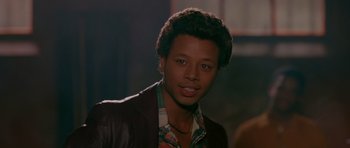 Movie still from “Dead Presidents” (1995), directed by Albert Hughes – A man with a brown leather jacket and a plaid shirt; Close Up shot, Low angle