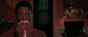 Movie still from “Dead Presidents” (1995), directed by Albert Hughes – A man with glasses is holding his mouth open; Close Up shot, Low angle