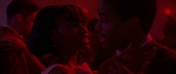 Movie still from “Dead Presidents” (1995), directed by Albert Hughes – A woman and a man in a red room; Close Up shot, Over the shoulder angle