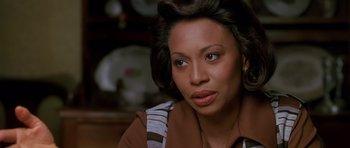 Movie still from “Dead Presidents” (1995), directed by Albert Hughes – A person wearing a brown shirt; Close Up shot, Over the shoulder angle