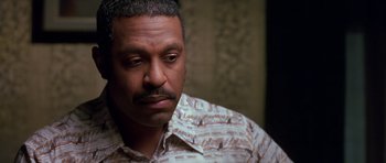 Movie still from “Dead Presidents” (1995), directed by Albert Hughes – A person wearing a shirt; Close Up shot, High angle