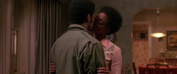 Movie still from “Dead Presidents” (1995), directed by Albert Hughes – A man and a woman kissing each other in front of a mirror; Close Up shot, Over the shoulder angle