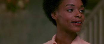 Movie still from “Dead Presidents” (1995), directed by Albert Hughes – A woman's face with a pink shirt; Close Up shot, Over the shoulder angle
