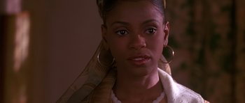 Movie still from “Dead Presidents” (1995), directed by Albert Hughes – A young woman wearing large gold hoop earrings; Close Up shot, Over the shoulder angle