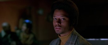 Movie still from “Dead Presidents” (1995), directed by Albert Hughes – A man with a beard is looking at the camera; Close Up shot, Low angle