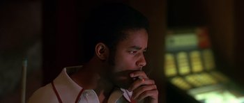 Movie still from “Dead Presidents” (1995), directed by Albert Hughes – A man with a cigarette in his mouth; Close Up shot, Low angle