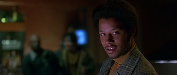 Movie still from “Dead Presidents” (1995), directed by Albert Hughes – A man in a yellow shirt is looking at the camera; Close Up shot, Low angle