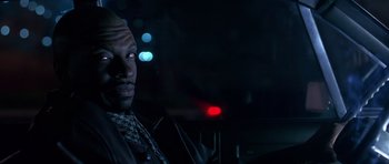 Movie still from “Dead Presidents” (1995), directed by Albert Hughes – A man in a black jacket is in the dark; Close Up shot, Low angle
