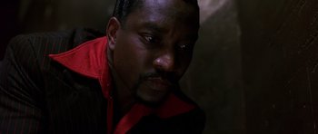 Movie still from “Dead Presidents” (1995), directed by Albert Hughes – A person wearing a red and black shirt; Close Up shot, High angle