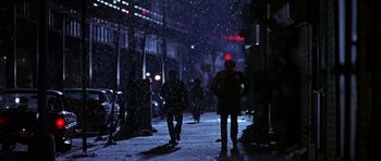 Movie still from “Dead Presidents” (1995), directed by Albert Hughes – A group of people walking down a street at night in the snow; Extreme Wide shot, Low angle