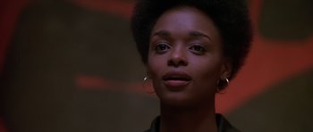 Movie still from “Dead Presidents” (1995), directed by Albert Hughes – A person wearing a black shirt; Close Up shot, Low angle