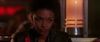 Movie still from “Dead Presidents” (1995), directed by Albert Hughes – A person wearing a leather jacket; Close Up shot, Over the shoulder angle