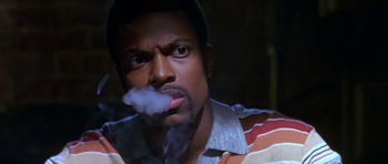 Movie still from “Dead Presidents” (1995), directed by Albert Hughes – A person smoking a cigarette; Close Up shot, Low angle