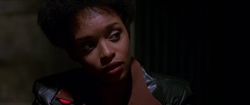Movie still from “Dead Presidents” (1995), directed by Albert Hughes – A person wearing a leather jacket; Close Up shot, Over the shoulder angle