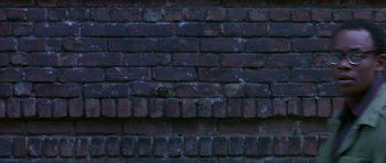 Movie still from “Dead Presidents” (1995), directed by Albert Hughes – View of a brick wall; Wide shot, Overhead angle