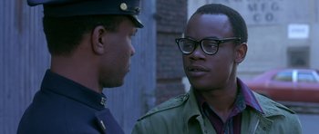 Movie still from “Dead Presidents” (1995), directed by Albert Hughes – Two men are standing next to each other talking; Close Up shot, Over the shoulder angle