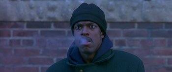 Movie still from “Dead Presidents” (1995), directed by Albert Hughes – A man with a cigarette in his mouth and wearing a hat; Close Up shot, Low angle