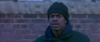 Movie still from “Dead Presidents” (1995), directed by Albert Hughes – A man in a black jacket and a black hat; Close Up shot, Low angle