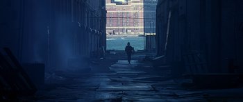 Movie still from “Dead Presidents” (1995), directed by Albert Hughes – A person is walking down the street in the dark; Extreme Wide shot, High angle