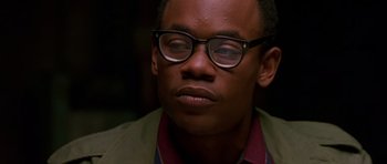 Movie still from “Dead Presidents” (1995), directed by Albert Hughes – A person wearing glasses with his eyes closed; Close Up shot, Low angle