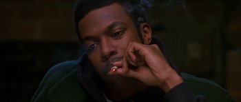 Movie still from “Dead Presidents” (1995), directed by Albert Hughes – A man smoking a cigarette while wearing a black jacket; Close Up shot, Low angle