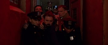 Movie still from “Dead Presidents” (1995), directed by Albert Hughes – A group of men in uniform are standing in a hallway; Medium shot, Low angle