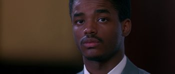 Movie still from “Dead Presidents” (1995), directed by Albert Hughes – A person wearing a suit and tie; Close Up shot, Low angle