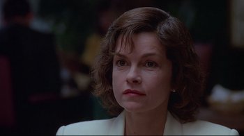 Movie still from “Dead Ringers” (1988), directed by David Cronenberg – A person wearing a suit and tie; Close Up shot, Low angle