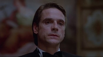 Movie still from “Dead Ringers” (1988), directed by David Cronenberg – A person wearing a suit and tie; Close Up shot, Low angle