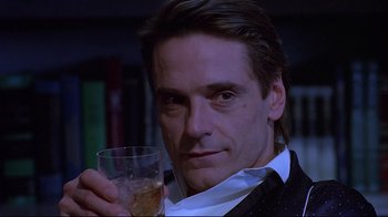 Movie still from “Dead Ringers” (1988), directed by David Cronenberg – A person holding a glass of wine; Close Up shot, Low angle