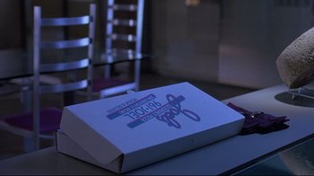 Movie still from “Dead Ringers” (1988), directed by David Cronenberg – A white box sitting on top of a wooden table; Extreme Close Up shot, High angle