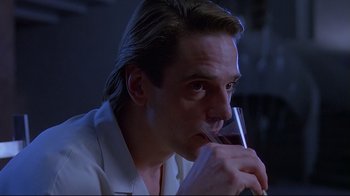 Movie still from “Dead Ringers” (1988), directed by David Cronenberg – A person holding a glass of wine; Close Up shot, Low angle