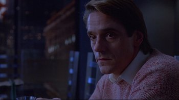 Movie still from “Dead Ringers” (1988), directed by David Cronenberg – A person wearing a pink shirt; Close Up shot, Low angle