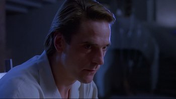 Movie still from “Dead Ringers” (1988), directed by David Cronenberg – A person wearing a white shirt; Close Up shot, Low angle