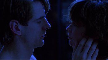 Movie still from “Dead Ringers” (1988), directed by David Cronenberg – A man and a woman face to face in the dark; Close Up shot, Low angle