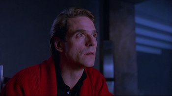 Movie still from “Dead Ringers” (1988), directed by David Cronenberg – A person wearing a red jacket; Close Up shot, Low angle