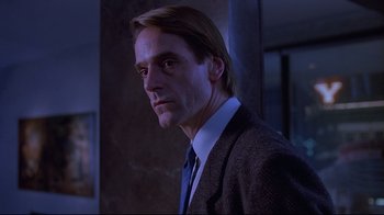Movie still from “Dead Ringers” (1988), directed by David Cronenberg – A person wearing a suit and tie; Close Up shot, Low angle