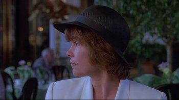 Movie still from “Dead Ringers” (1988), directed by David Cronenberg – A person wearing a hat; Close Up shot, Over the shoulder angle