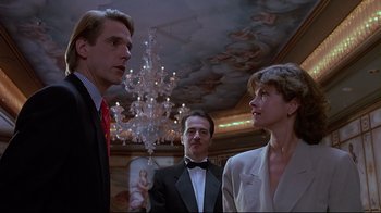 Movie still from “Dead Ringers” (1988), directed by David Cronenberg – A group of people standing in front of chandeliers; Medium shot, Low angle